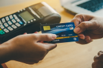 Person handing credit card to cashier