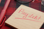 note that says pay debt